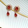 Металева серединка 24 * 45мм. Золота основа з червоним камінчиком та  підвіскоюкришталевими стразами.